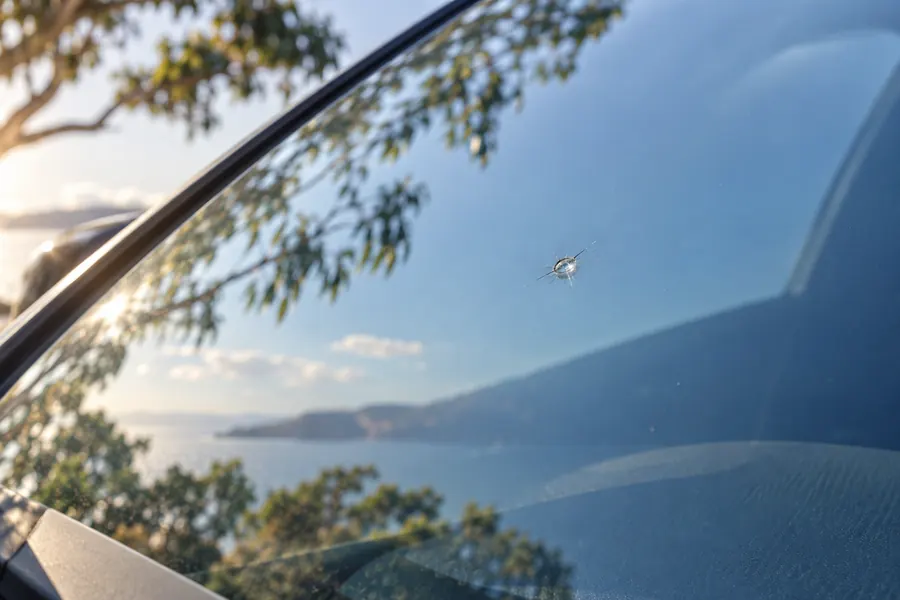 Illustrative close-up of a stone chip in windscreen glass