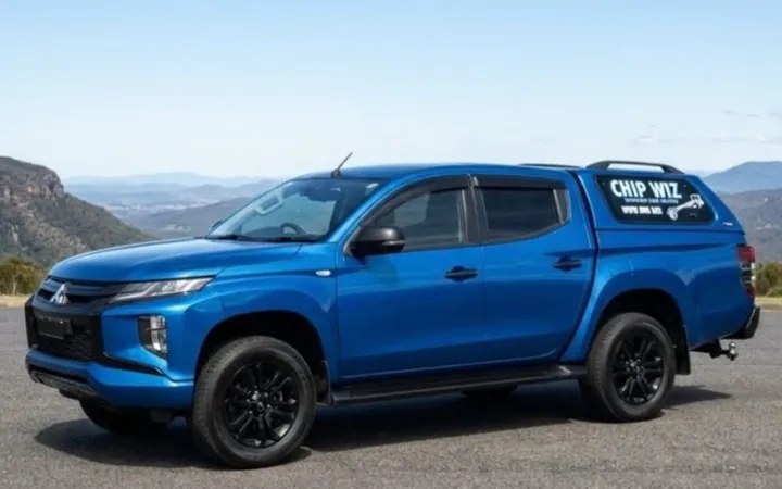 The Chip Wiz mobile service ute, a blue Mitsubishi Triton with a CHIP WIZ sign on its canopy side window